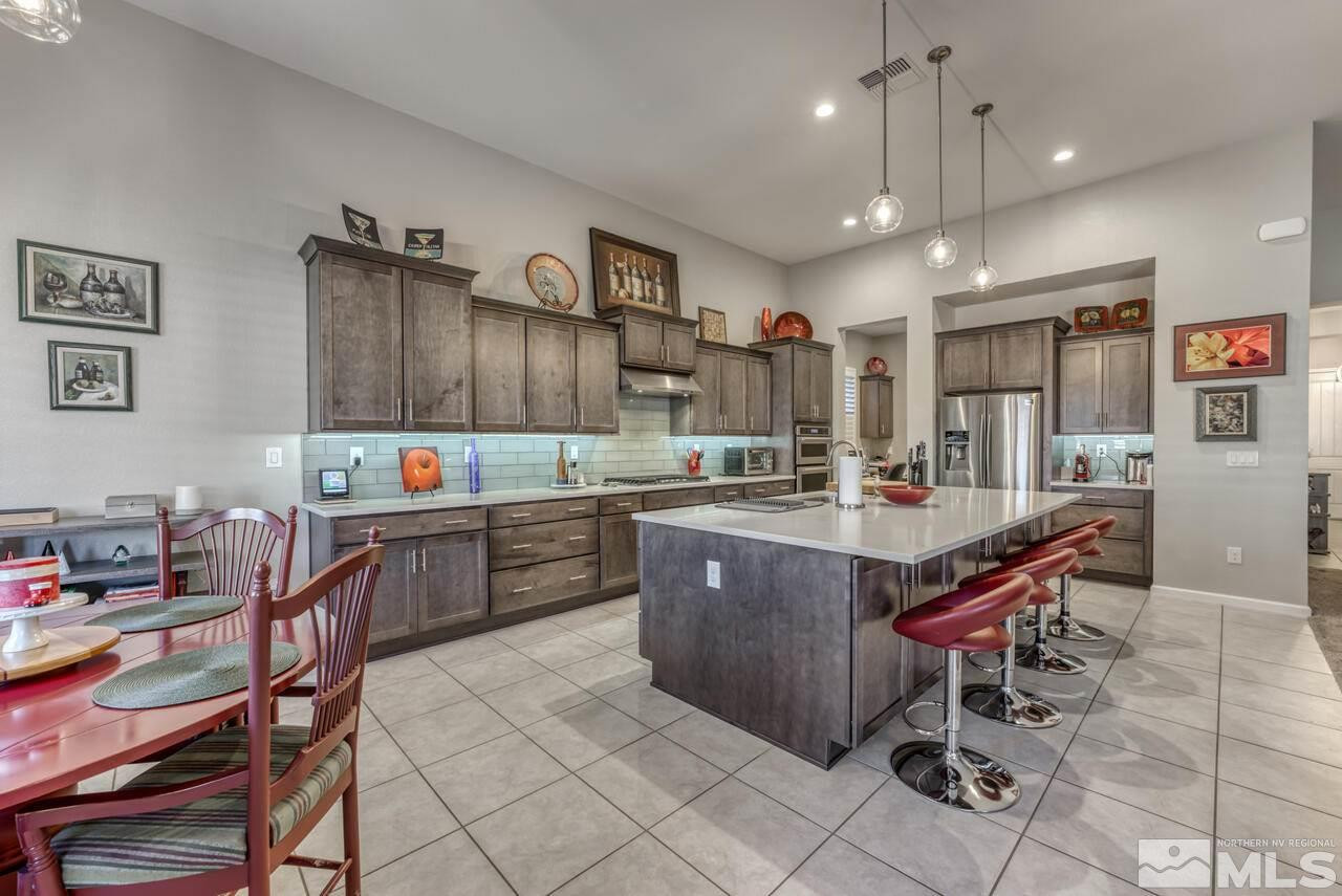 9470 Baldacci Road Reno, NV 89521 - Photo 10 of 35 a kitchen with granite countertop stainless steel appliances a sink and a center island