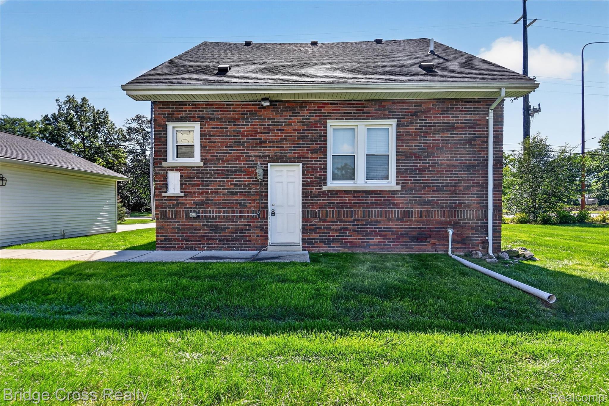 285 East Long Lake Road Troy, MI 48085 - Photo 38 of 49 Brick exterior with white trim windows and a white entry door