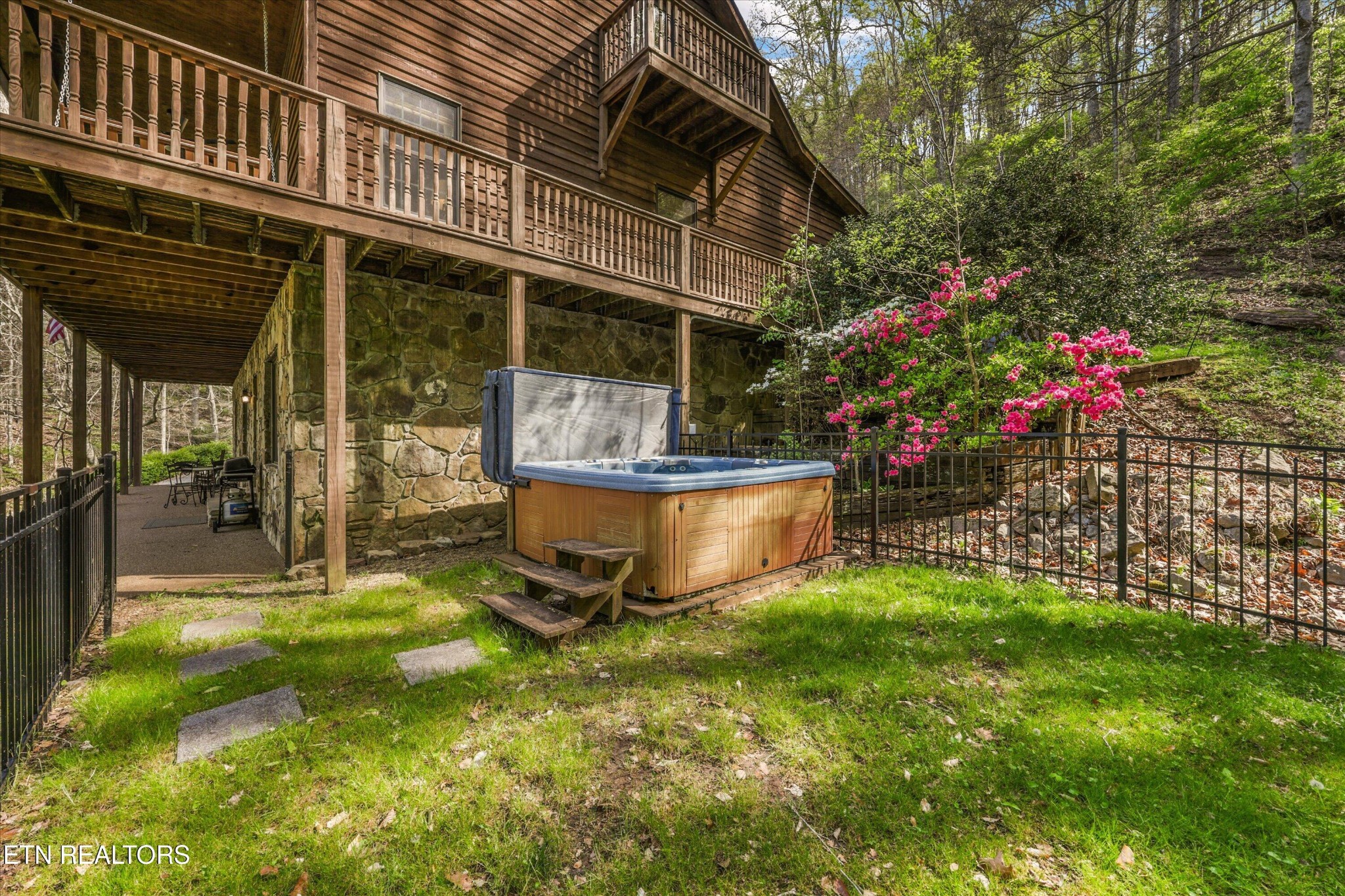 257 Lone Ridge Lane Heiskell, TN 37754 - Photo 4 of 60 a backyard of a house with table and chairs and potted plants