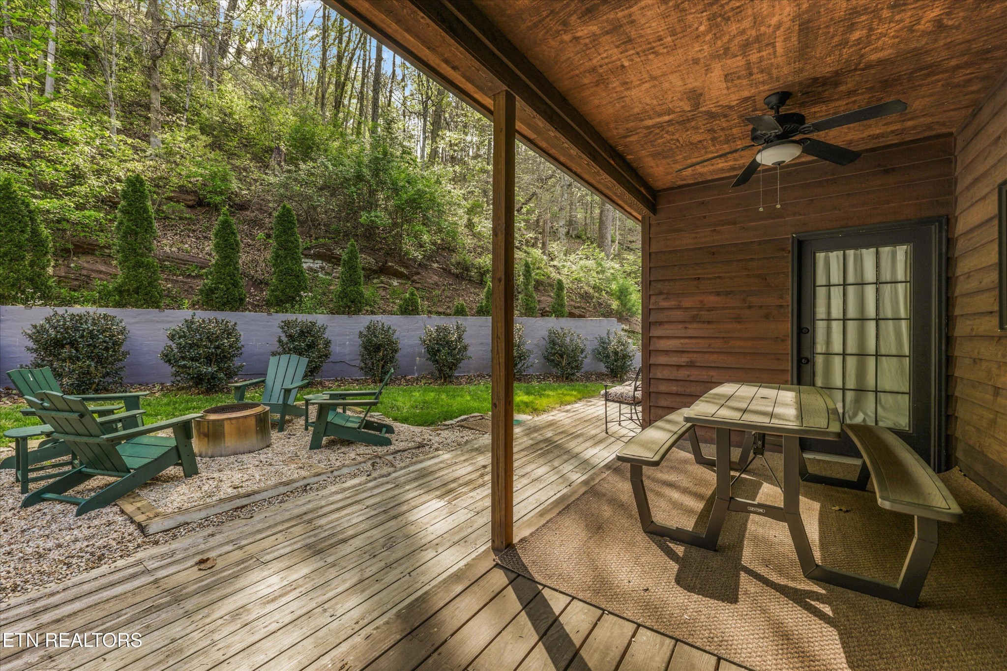 257 Lone Ridge Lane Heiskell, TN 37754 - Photo 8 of 60 a view of a patio with table and chairs potted plants with wooden floor and fence