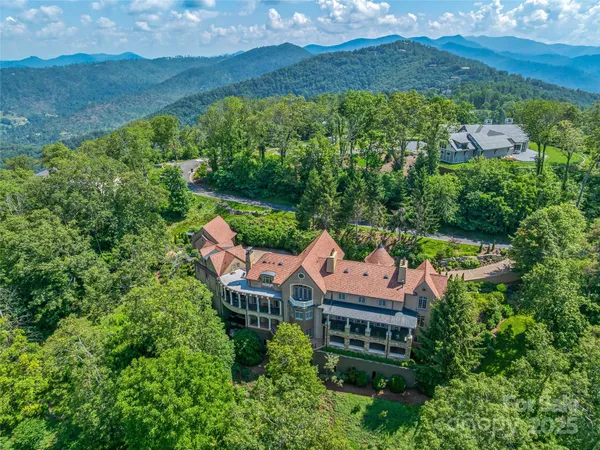 an aerial view of house with yard and mountain view