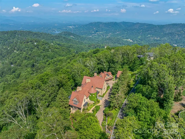 an aerial view of a house with a yard