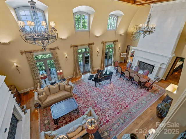 a living room with furniture and a chandelier