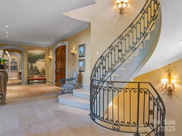 a view of entryway and hall with wooden floor and a livingroom view