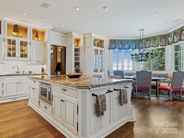 a kitchen with stainless steel appliances granite countertop a stove and cabinets