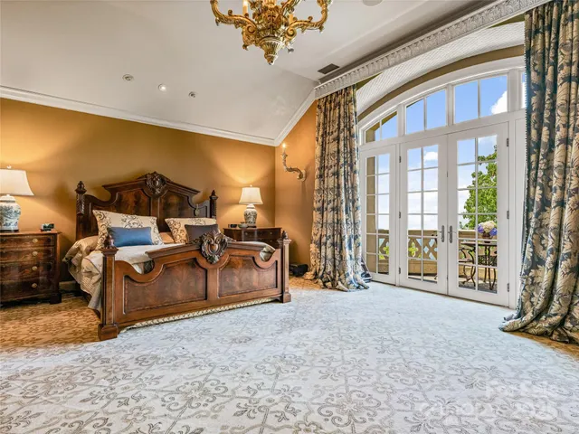 a bedroom with furniture and a floor to ceiling window