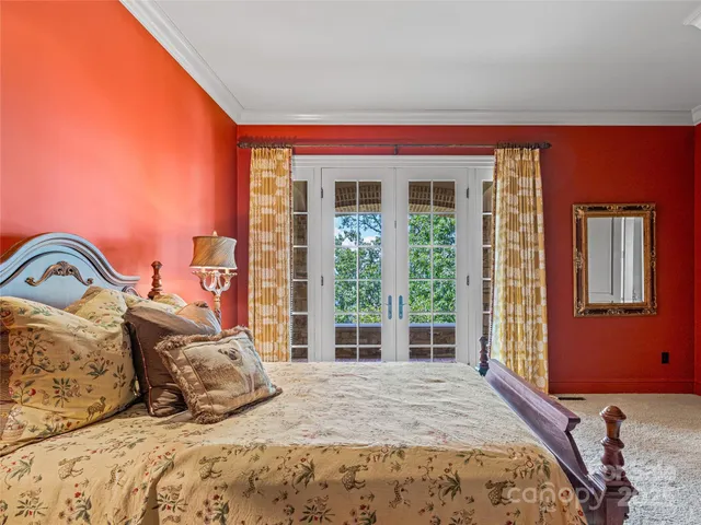 a bedroom with a bed next to a window