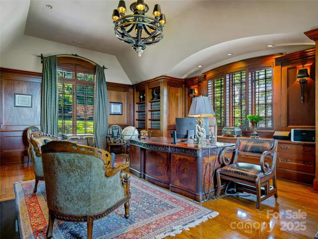 a living room with furniture a rug and a large window
