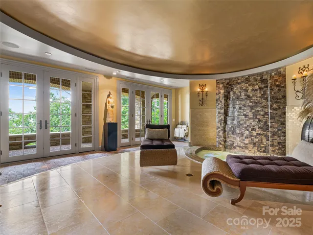 a view of a livingroom with furniture and floor to ceiling window