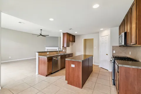 a kitchen with stainless steel appliances granite countertop a stove and a refrigerator