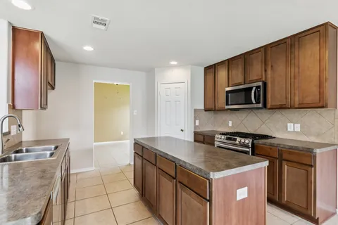 a kitchen with a sink stove and microwave