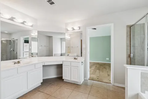 a spacious bathroom with a double vanity sink mirror and