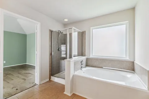 a bathroom with a bathtub and a shower