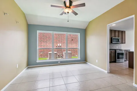 a living room with a fireplace furniture and a large window
