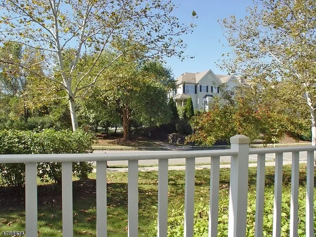 a view of a brick house with a trees