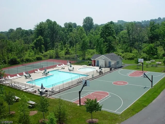 a kitchen with granite countertop white cabinets and stainless steel appliances