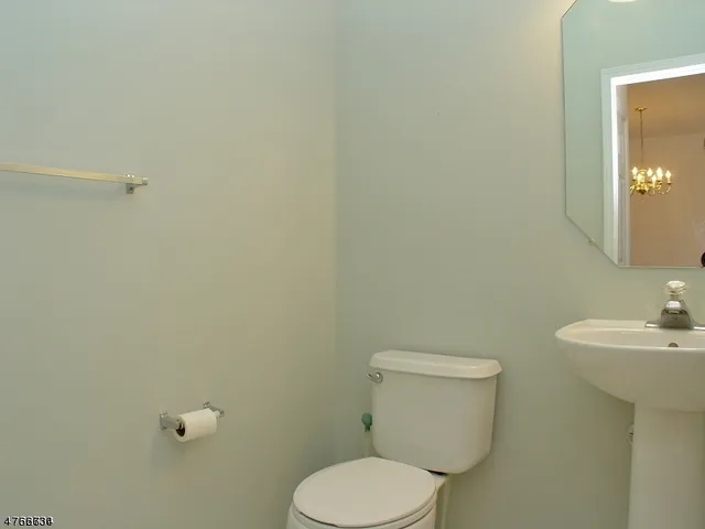 a white toilet sitting next to a bathroom sink