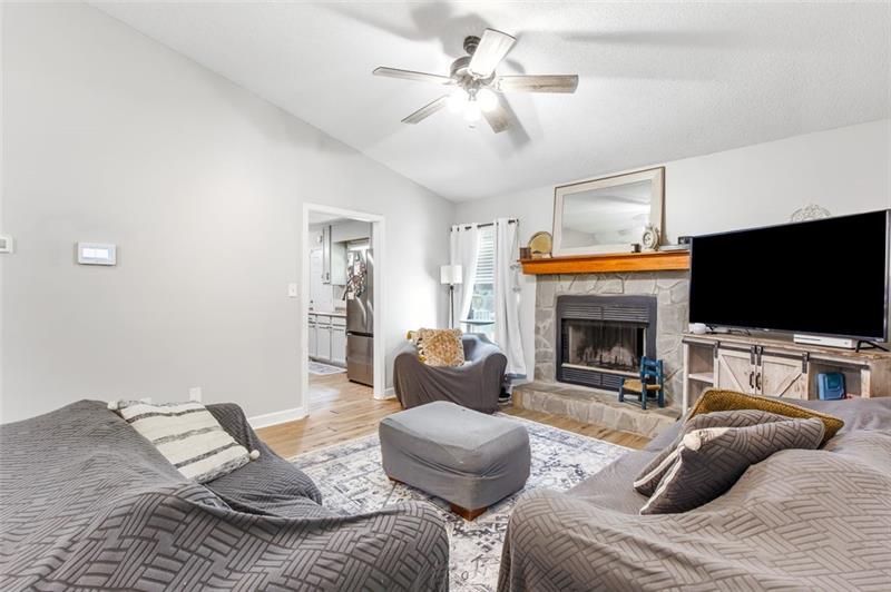 237 Mona Place Dallas, GA 30132 - Photo 11 of 28 a living room with furniture a flat screen tv and a fireplace