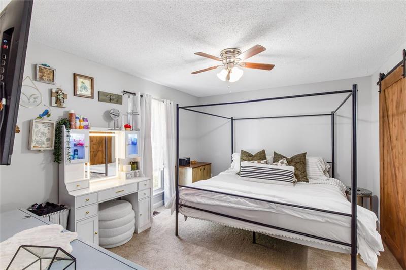 237 Mona Place Dallas, GA 30132 - Photo 13 of 28 a bedroom with a bed and a chandelier