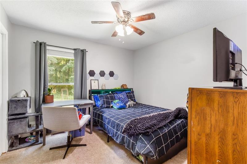 237 Mona Place Dallas, GA 30132 - Photo 17 of 28 a bedroom with a bed window and a table