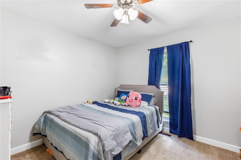 237 Mona Place Dallas, GA 30132 - Photo 18 of 28 a bedroom with a bed and a chandelier