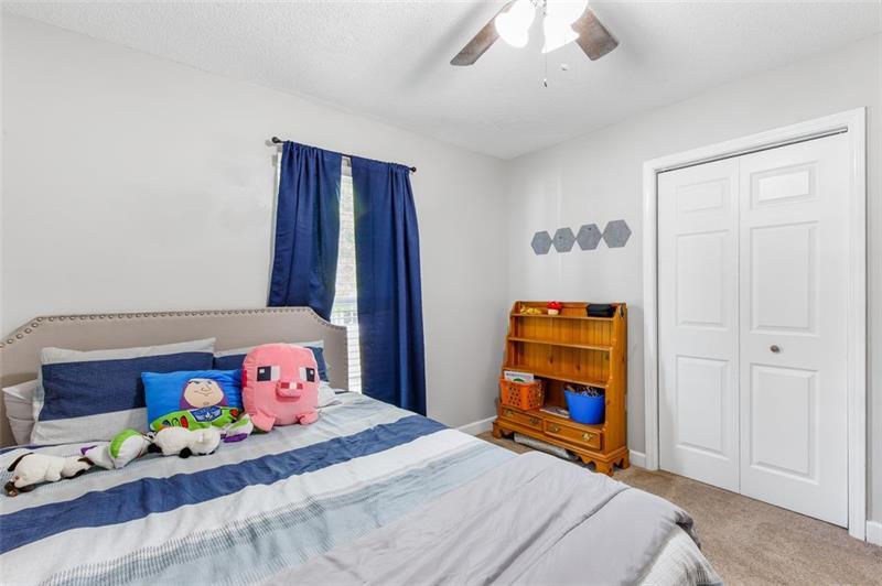237 Mona Place Dallas, GA 30132 - Photo 19 of 28 a bedroom with a bed and wooden floor