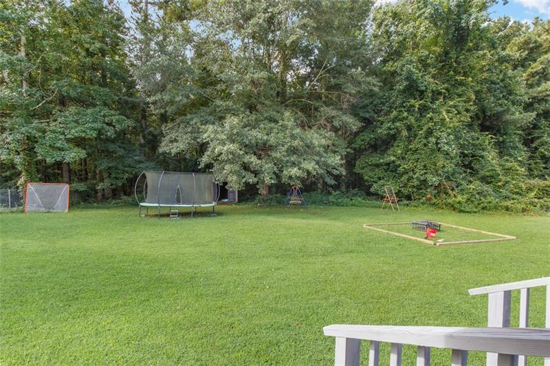 237 Mona Place Dallas, GA 30132 - Photo 24 of 28 a view of a wooden fence and trees