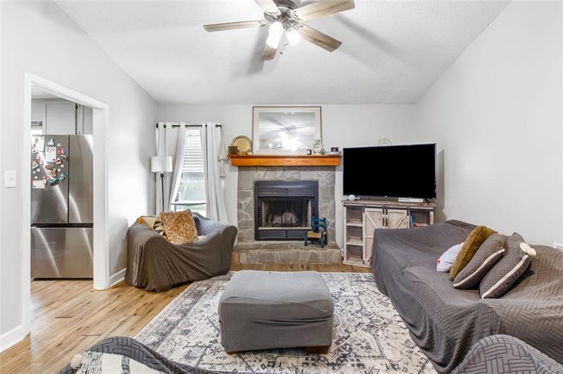 237 Mona Place Dallas, GA 30132 - Photo 6 of 28 a living room with furniture a flat screen tv and a fireplace