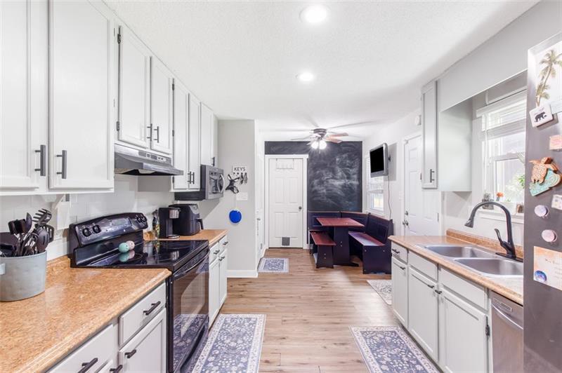 237 Mona Place Dallas, GA 30132 - Photo 9 of 28 a kitchen with stainless steel appliances granite countertop a sink stove and refrigerator