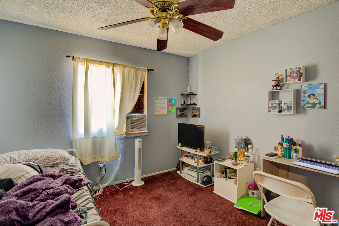 16660 Quinnault Road Apple Valley, CA 92307 - Photo 14 of 20 a bedroom with furniture and a window