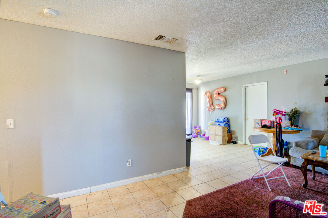 16660 Quinnault Road Apple Valley, CA 92307 - Photo 4 of 20 a living room with furniture and a wooden floor