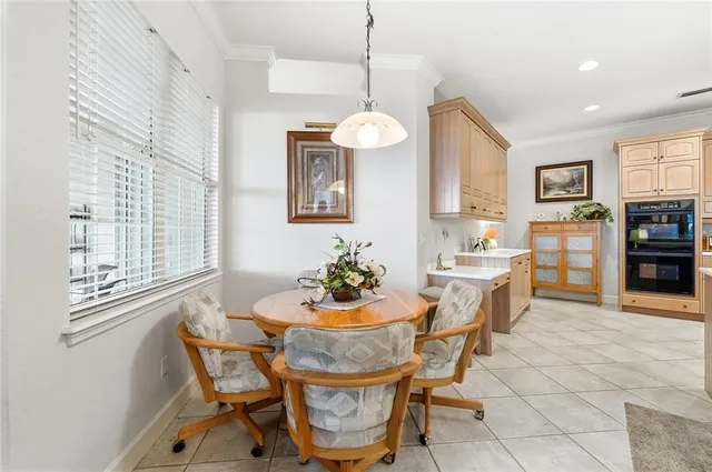 a dining room with furniture a chandelier and window