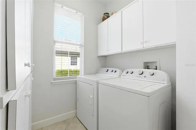 a view of a room with furniture and large windows