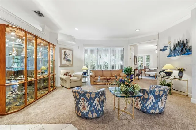a living room with furniture and large windows