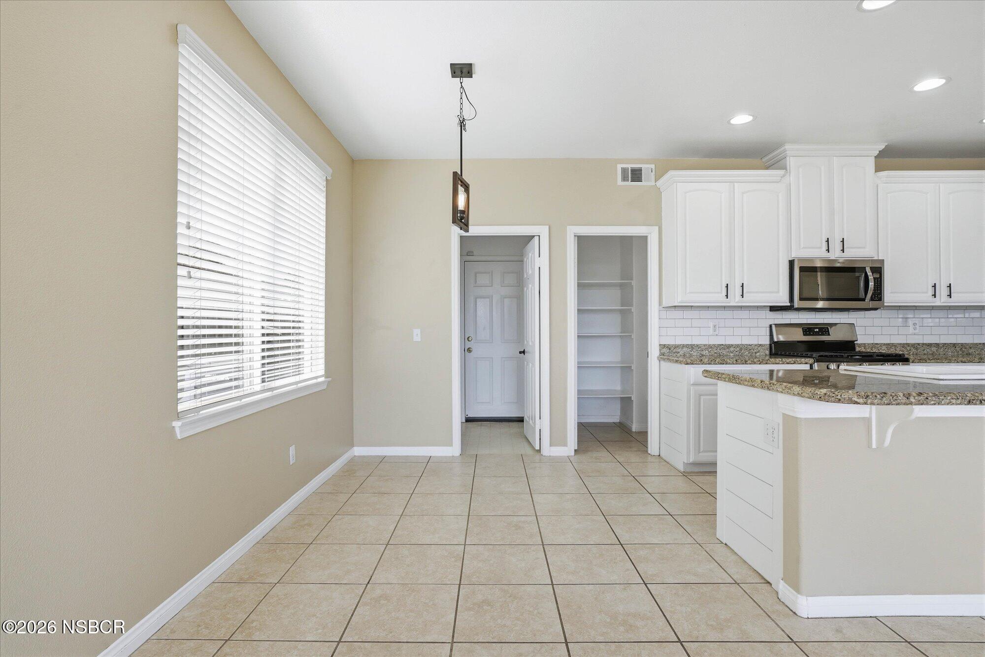 280 Rinconcito Lompoc, CA 93436 - Photo 13 of 39 a open kitchen with stainless steel appliances granite countertop a refrigerator and a stove top oven