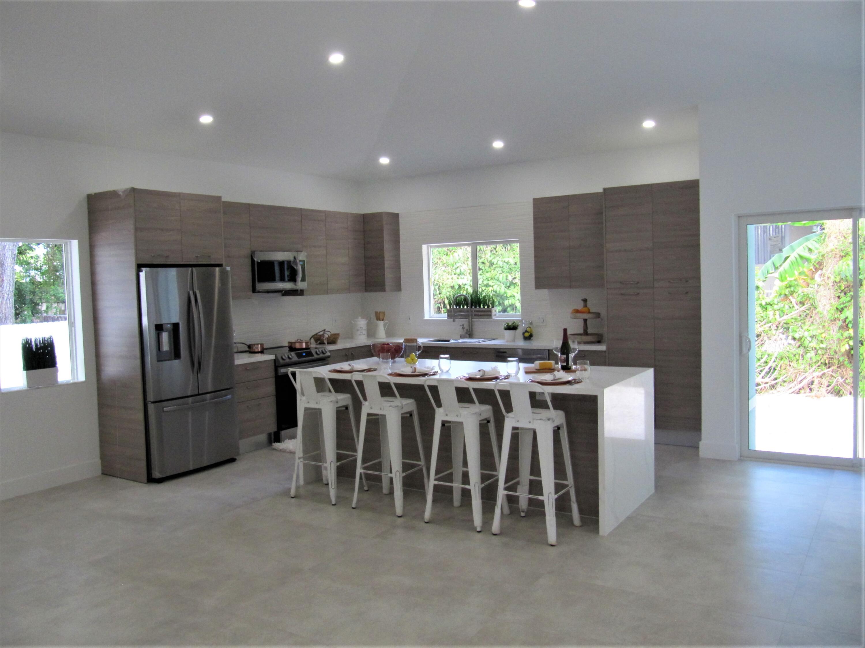 441 4th Road Key Largo, FL 33037 - Photo 3 of 18 a kitchen with kitchen island a sink stove and refrigerator