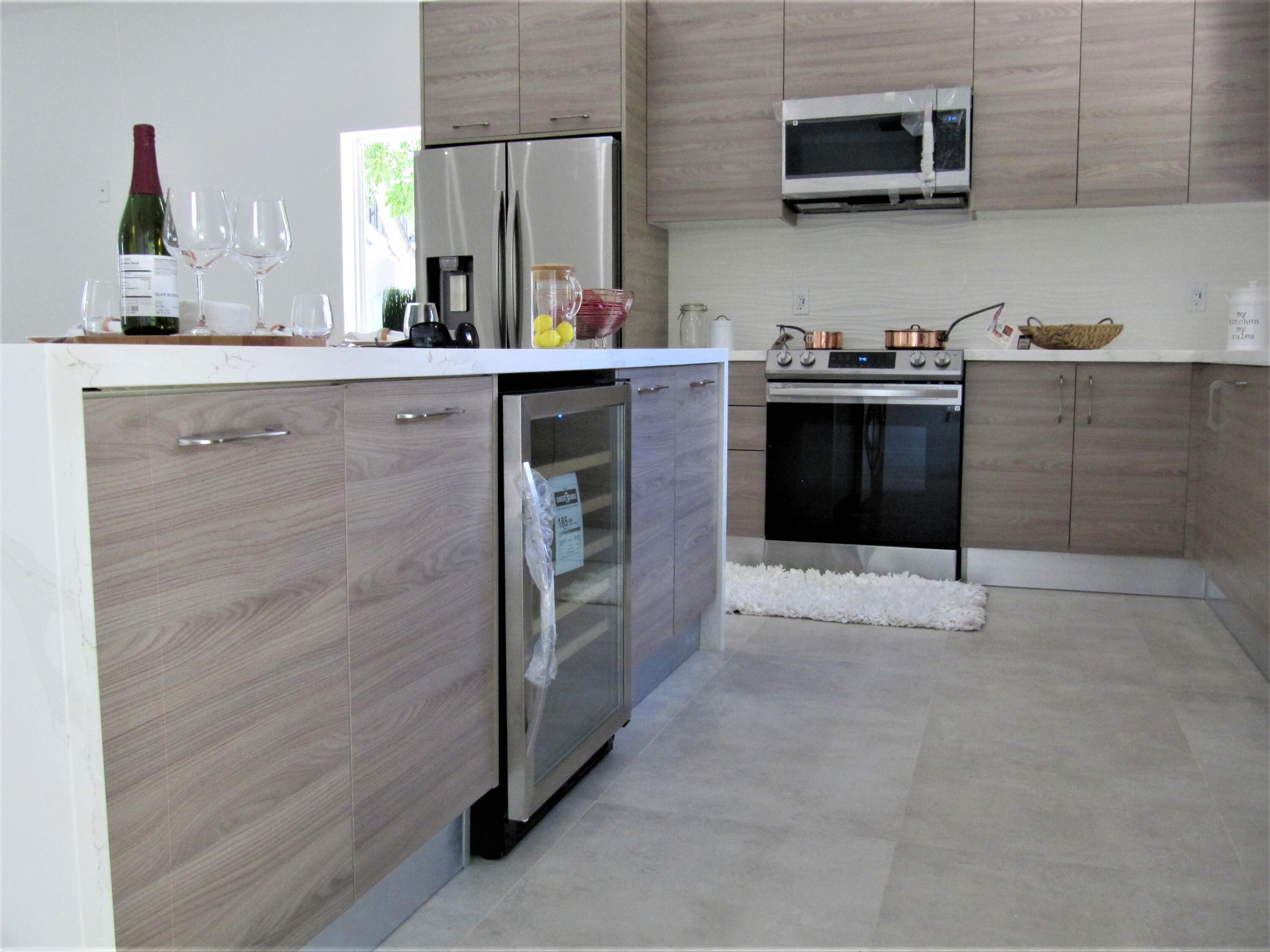 441 4th Road Key Largo, FL 33037 - Photo 5 of 18 a kitchen with stainless steel appliances a stove and cabinets