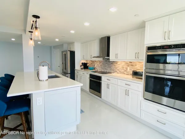 a kitchen with a stove a sink and a refrigerator