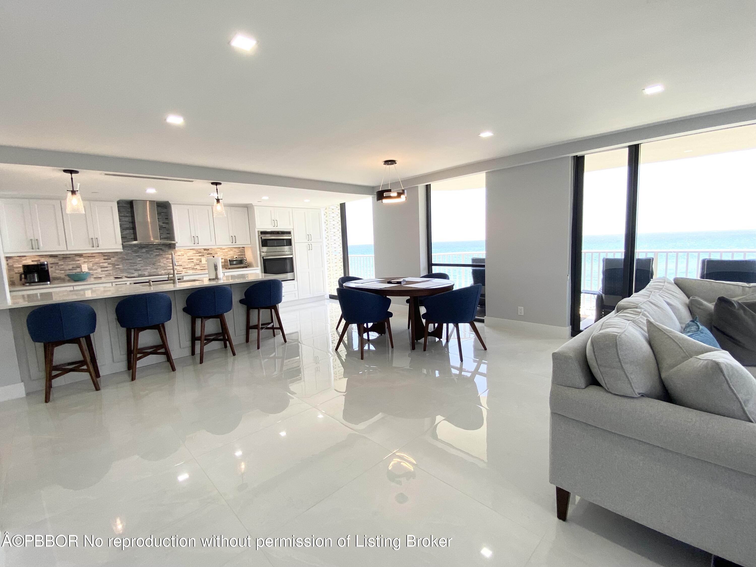 3360 South Ocean Boulevard, Unit 4FII Palm Beach, FL 33480 - Photo 17 of 32 a living room with furniture a dining table and a large window