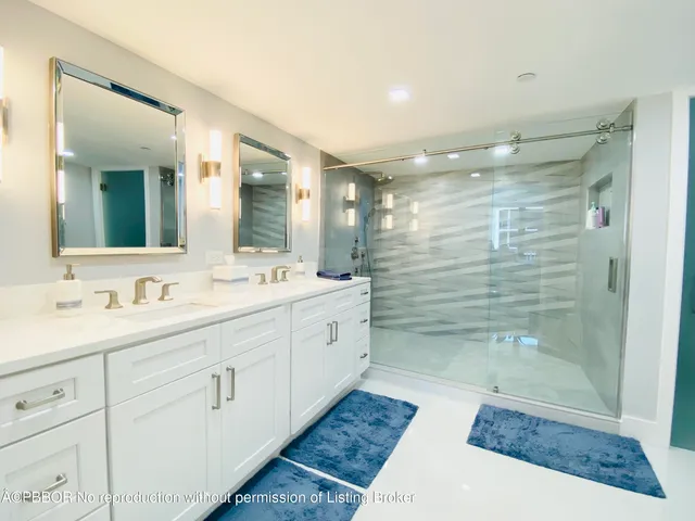 a bathroom with a shower sink and mirror