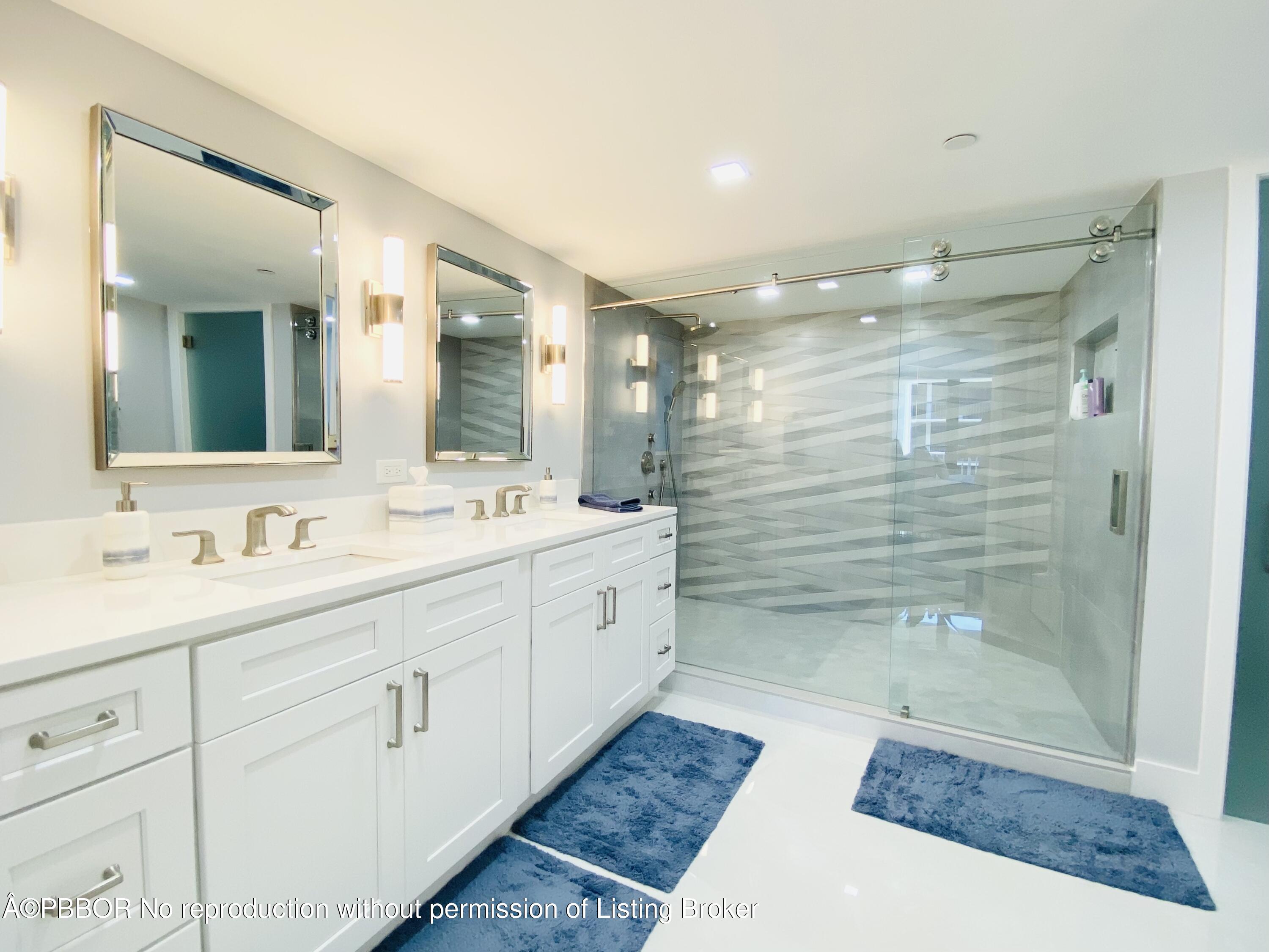 3360 South Ocean Boulevard, Unit 4FII Palm Beach, FL 33480 - Photo 20 of 32 a bathroom with a shower sink and mirror