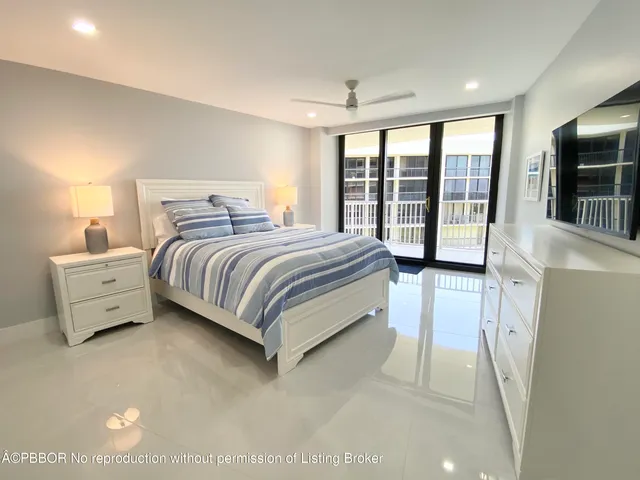 a spacious bedroom with a bed and a large window