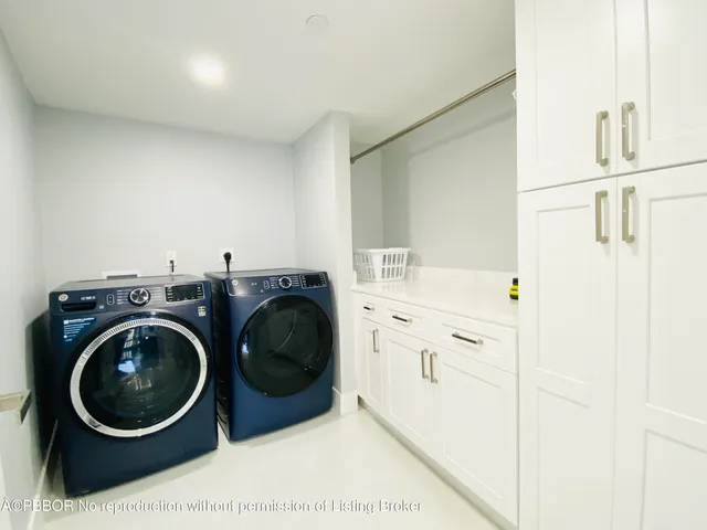 a utility room with sink dryer and washer