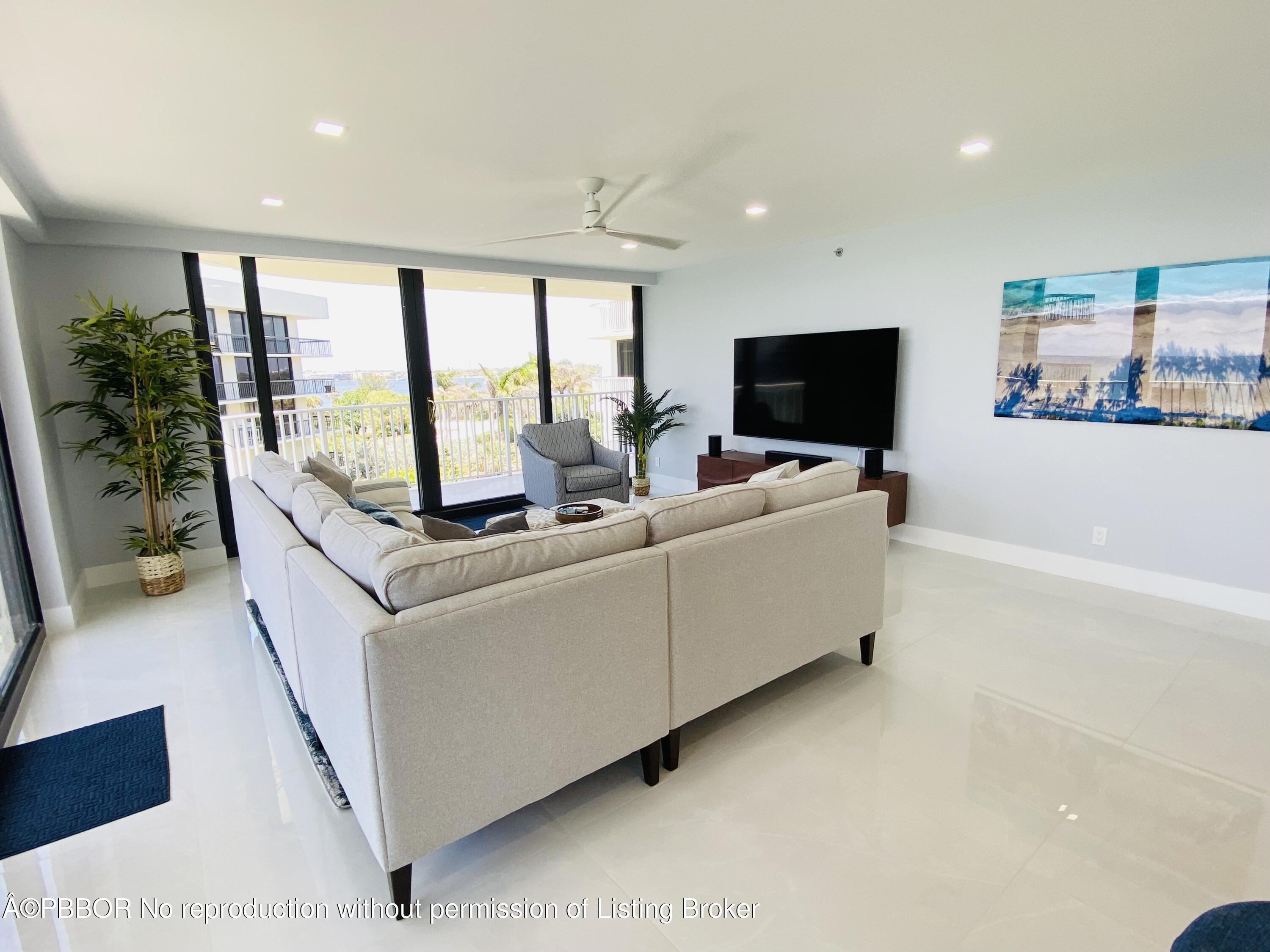 3360 South Ocean Boulevard, Unit 4FII Palm Beach, FL 33480 - Photo 5 of 32 a living room with furniture and a flat screen tv