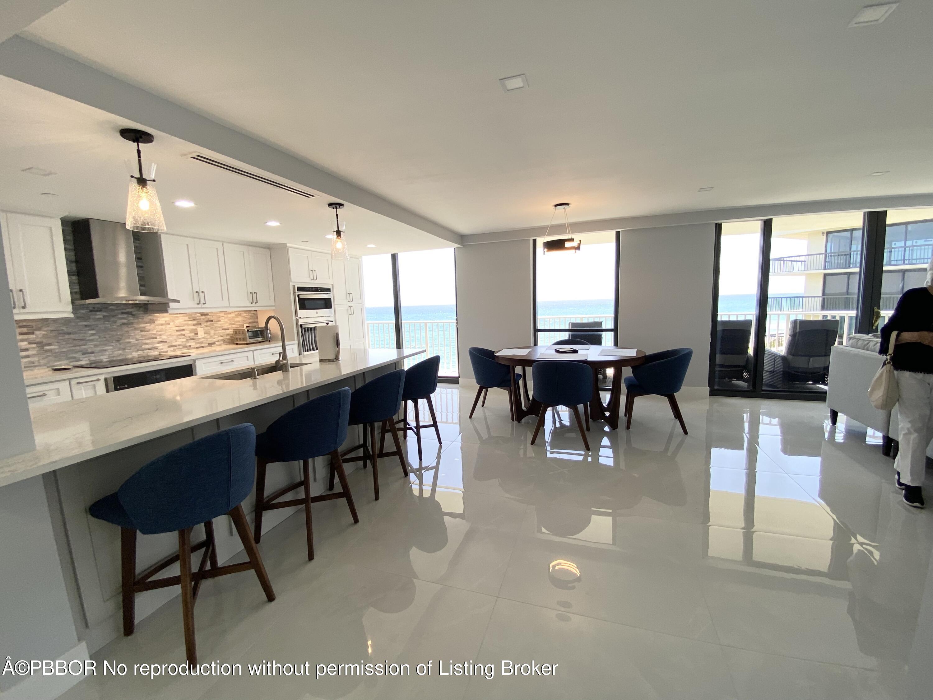 3360 South Ocean Boulevard, Unit 4FII Palm Beach, FL 33480 - Photo 6 of 32 a dining hall with stainless steel appliances kitchen island granite countertop furniture and a large window