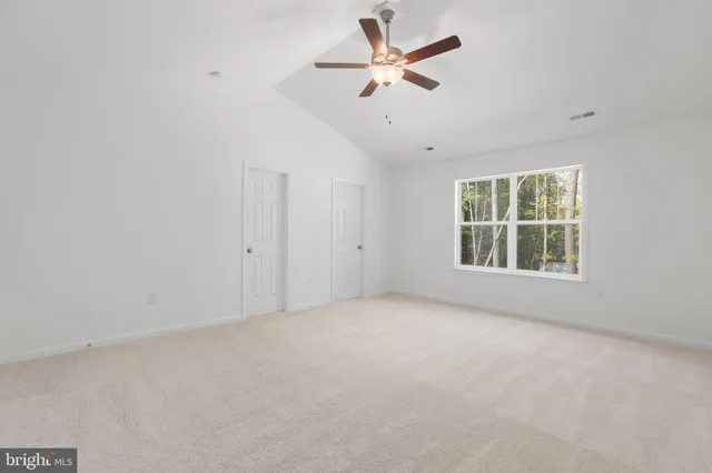 a bathroom with a double vanity sink a toilet and a bathtub