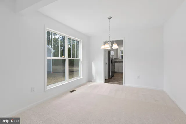 a view of an empty room with windows