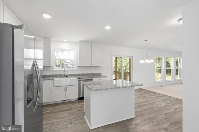 a kitchen with a refrigerator sink and cabinets