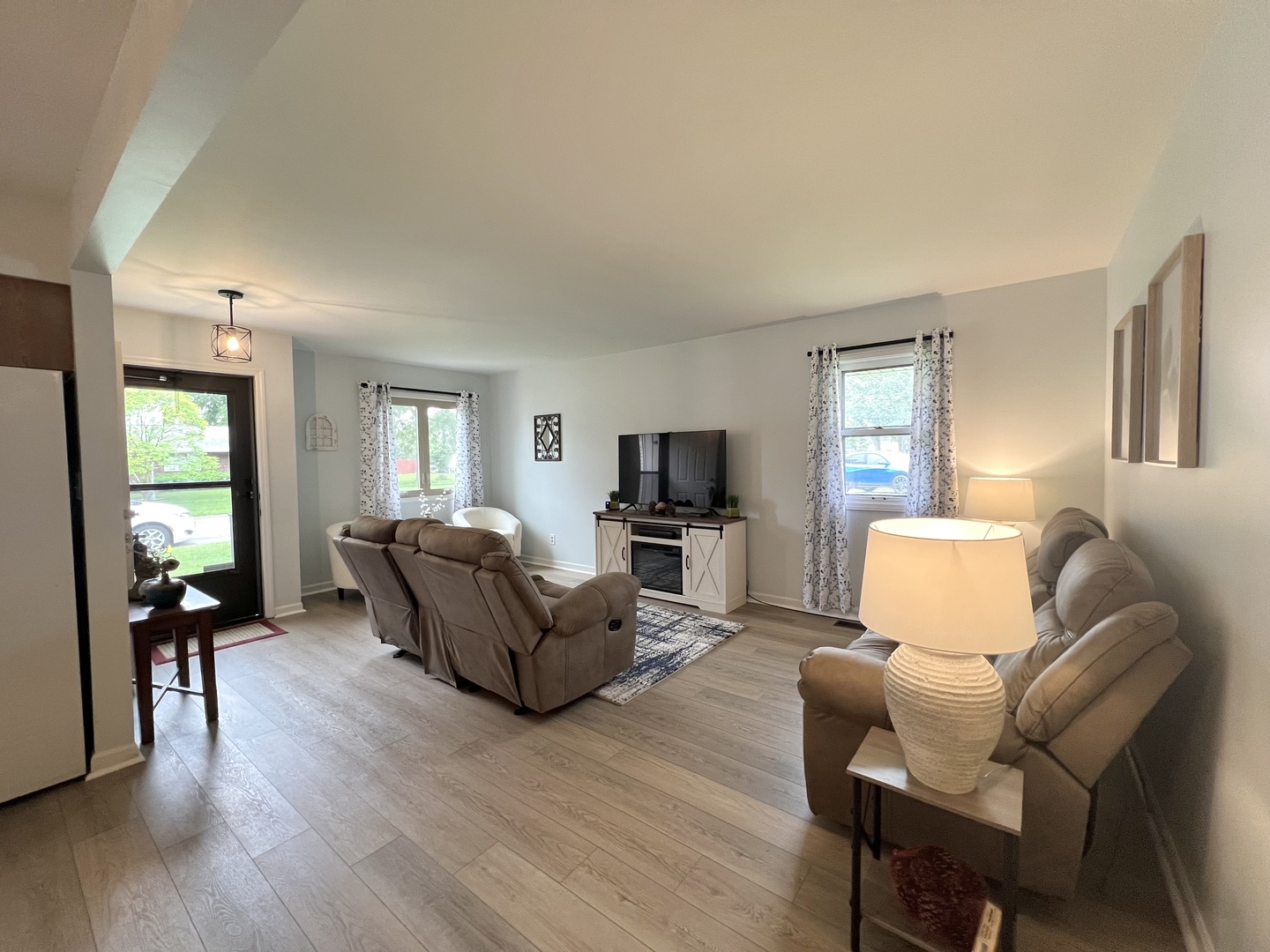 1201 Clark Street Rantoul, IL 61866 - Photo 7 of 24 a living room with furniture and a flat screen tv with wooden floor