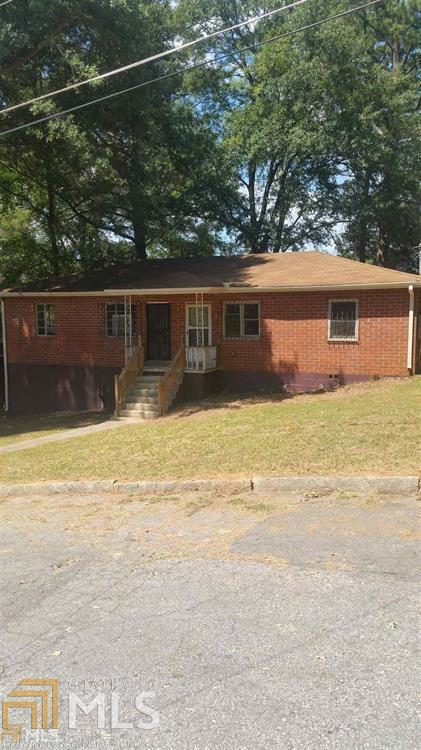 1897 Phillips Avenue East Point, GA 30344 - Photo 1 of 1 a view of a house with a yard and a large tree